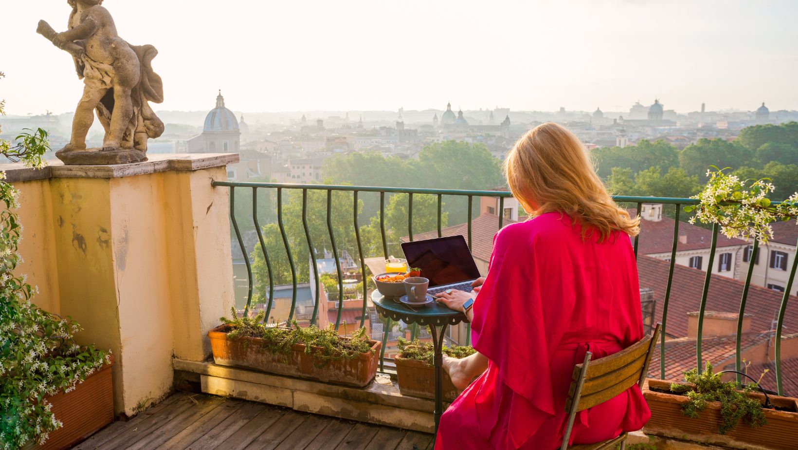 woman working on laptop with Italian scenery